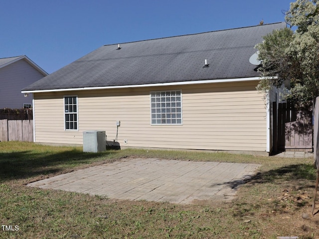 rear view of property with central air condition unit and a patio