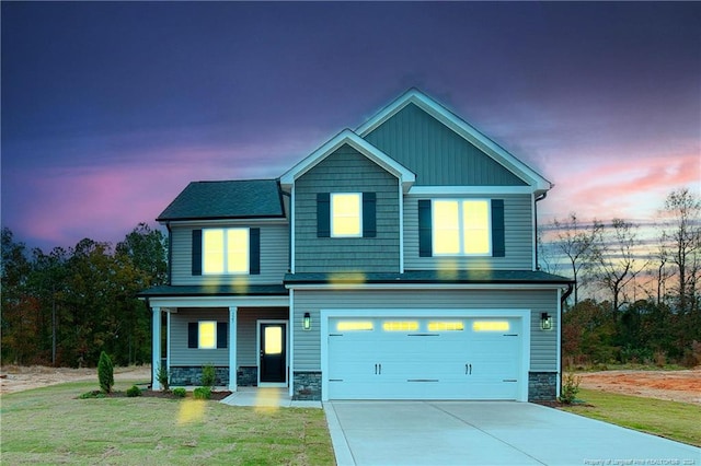 view of front of home featuring a garage and a yard