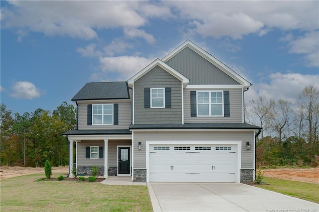 craftsman inspired home with a garage and a front lawn