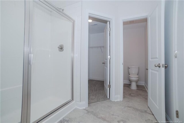 bathroom with toilet and walk in shower