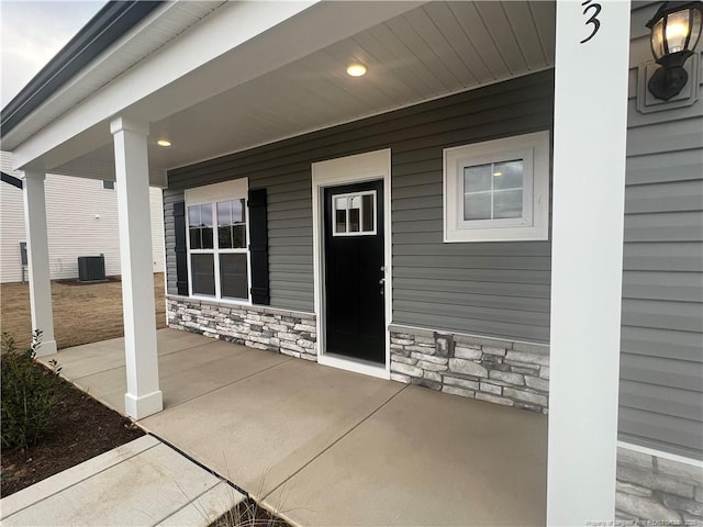 property entrance featuring a porch and central AC unit