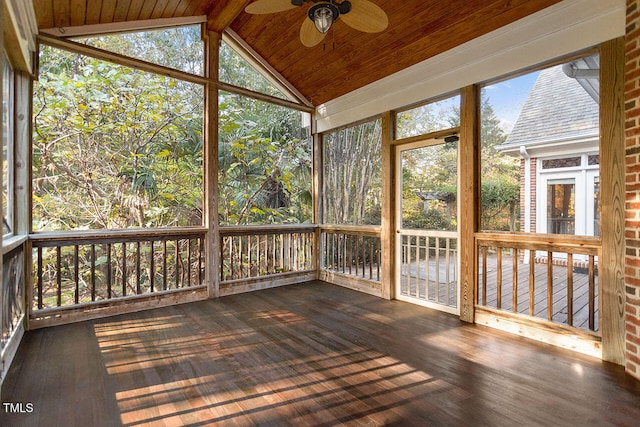 unfurnished sunroom featuring ceiling fan, wood ceiling, and vaulted ceiling with beams