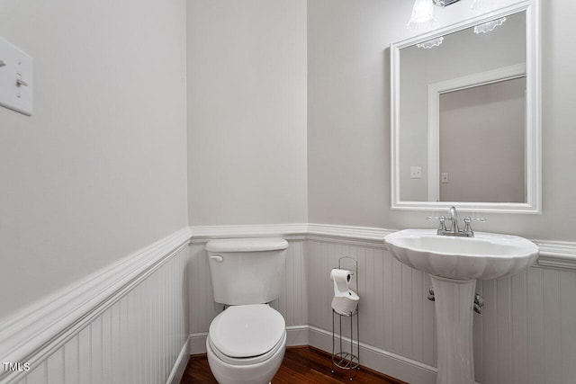 bathroom featuring toilet, sink, and hardwood / wood-style floors