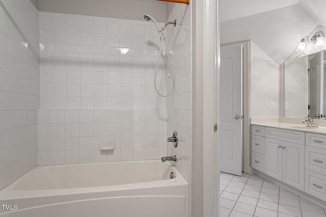 bathroom featuring vanity, tile patterned floors, and tiled shower / bath combo