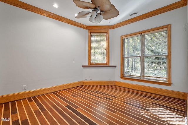 spare room featuring crown molding, hardwood / wood-style flooring, and ceiling fan