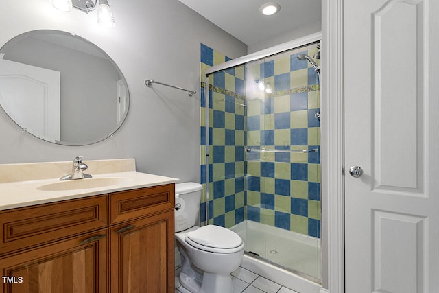 bathroom featuring vanity, tile patterned floors, toilet, and walk in shower