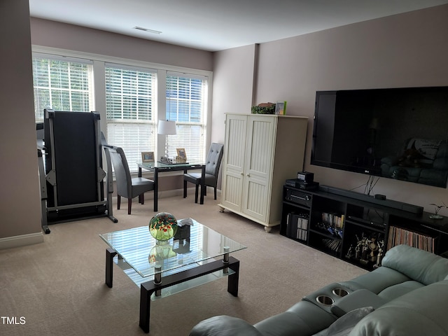 living room featuring light carpet, visible vents, and baseboards