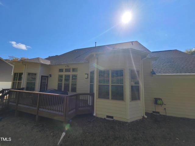 back of house featuring a wooden deck