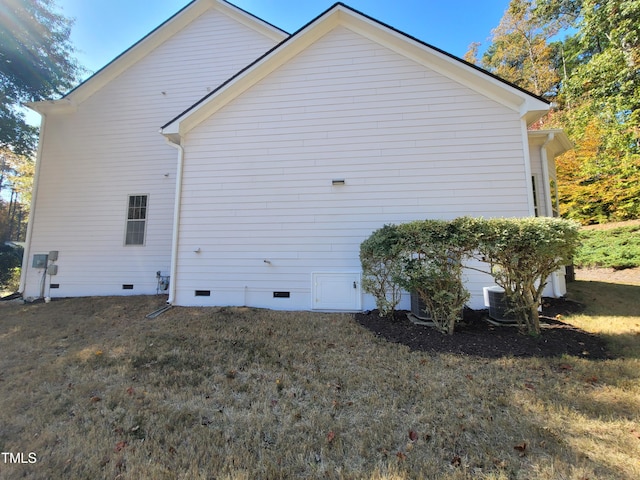 view of property exterior featuring crawl space and a lawn