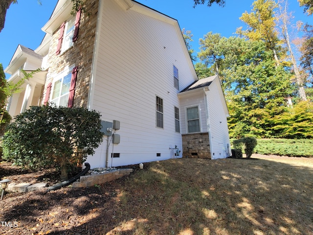 view of home's exterior featuring stone siding and crawl space