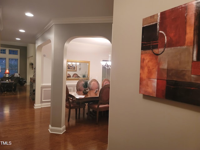 hall featuring recessed lighting, crown molding, arched walkways, and wood finished floors