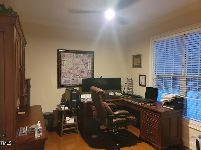 home office featuring a ceiling fan, ornamental molding, and wood finished floors