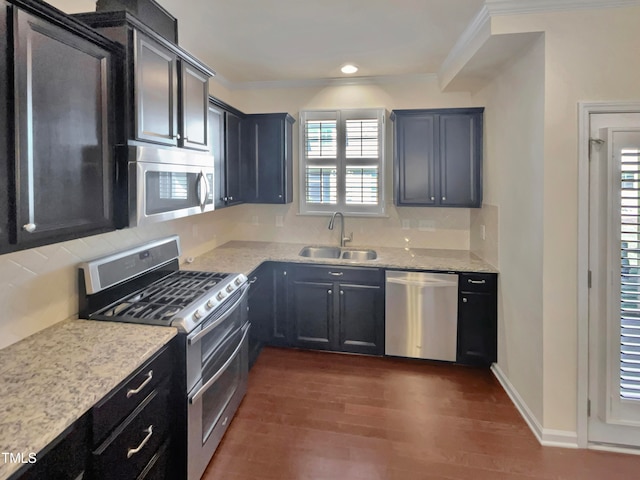 kitchen featuring light stone countertops, sink, stainless steel appliances, dark wood-type flooring, and ornamental molding