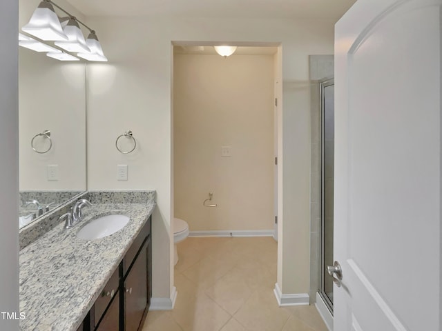 bathroom with vanity, toilet, a shower with shower door, and tile patterned flooring