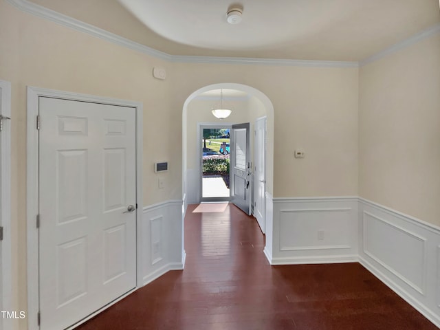 entrance foyer with crown molding and dark hardwood / wood-style floors