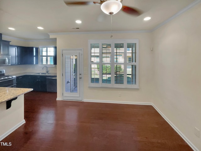 kitchen with dark wood-type flooring, black appliances, ornamental molding, and sink