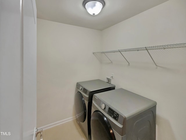 laundry room with washing machine and clothes dryer