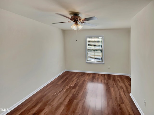 empty room featuring ceiling fan and dark hardwood / wood-style flooring