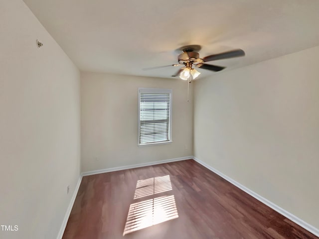 empty room featuring dark wood-type flooring and ceiling fan