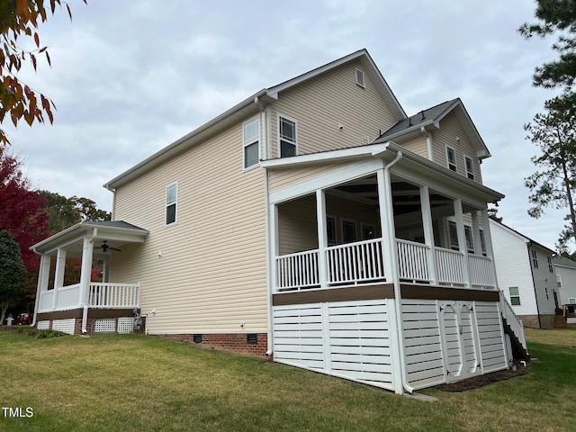 view of property exterior with a yard and ceiling fan