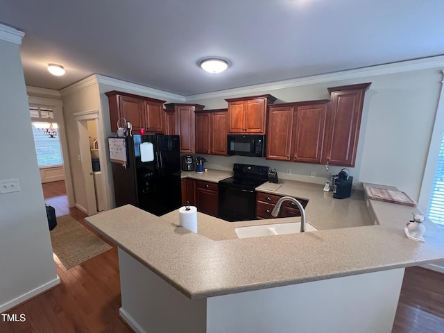 kitchen with sink, black appliances, kitchen peninsula, and crown molding