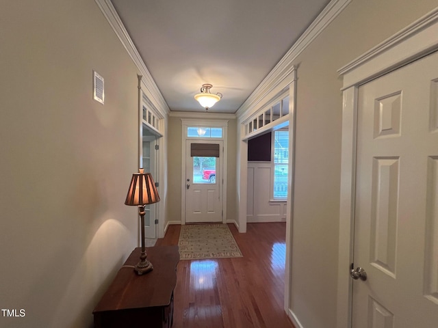 doorway with crown molding and dark wood-type flooring