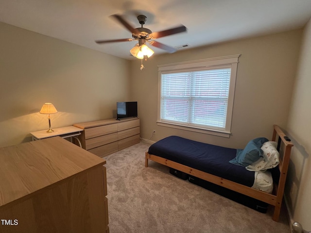 bedroom with light carpet and ceiling fan