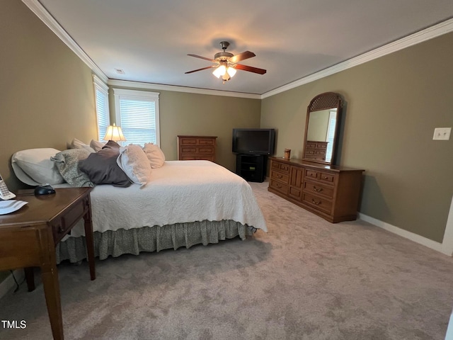 carpeted bedroom with ornamental molding and ceiling fan