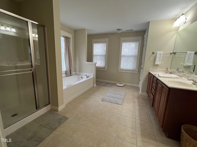 bathroom featuring vanity, tile patterned floors, plenty of natural light, and plus walk in shower