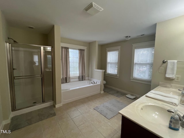 full bathroom featuring vanity, shower with separate bathtub, toilet, and tile patterned floors