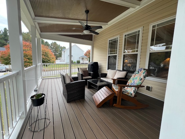 wooden terrace with an outdoor living space and ceiling fan