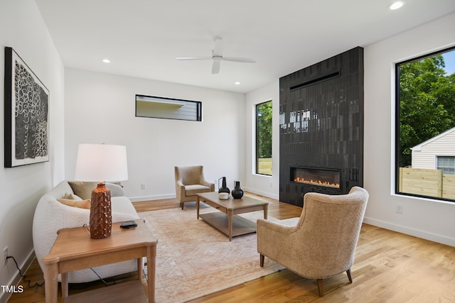 713 N State St, Raleigh, NC 27604 - living area with plenty of natural light, wood finished floors, a large fireplace, recessed lighting, and a ceiling fan