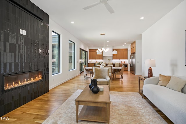713 N State St, Raleigh, NC 27604 - living room featuring a fireplace, light wood finished floors, a chandelier, recessed lighting, and ceiling fan