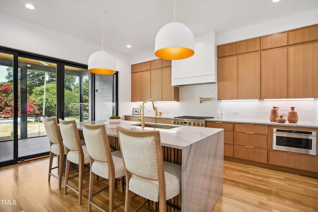 713 N State St, Raleigh, NC 27604 - kitchen featuring modern cabinets, tasteful backsplash, light wood-type flooring, and recessed lighting