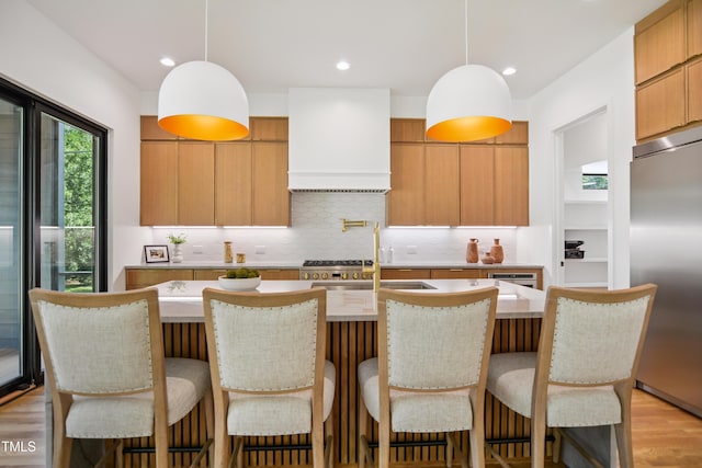 713 N State St, Raleigh, NC 27604 - kitchen with stainless steel built in refrigerator, custom exhaust hood, tasteful backsplash, pendant lighting, and recessed lighting