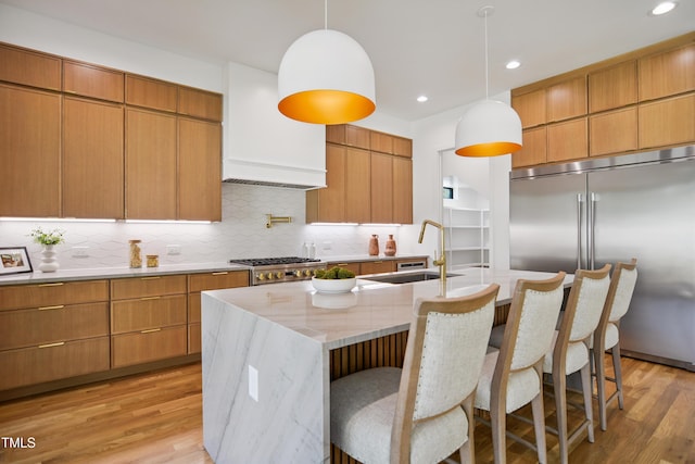713 N State St, Raleigh, NC 27604 - kitchen featuring stainless steel appliances, light wood-type flooring, decorative backsplash, modern cabinets, and recessed lighting