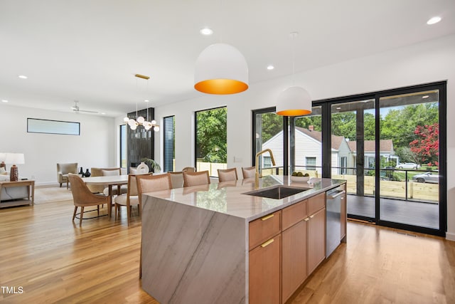 713 N State St, Raleigh, NC 27604 - kitchen featuring open floor plan, an island with sink, light wood-type flooring, light stone counters, and dishwasher