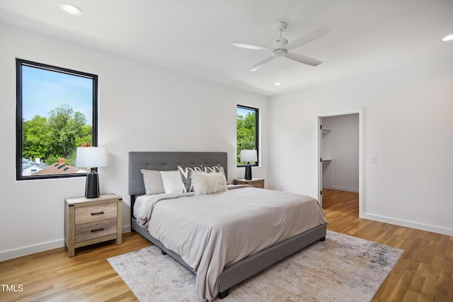 713 N State St, Raleigh, NC 27604 - bedroom featuring light wood-style flooring, a ceiling fan, recessed lighting, and a walk in closet