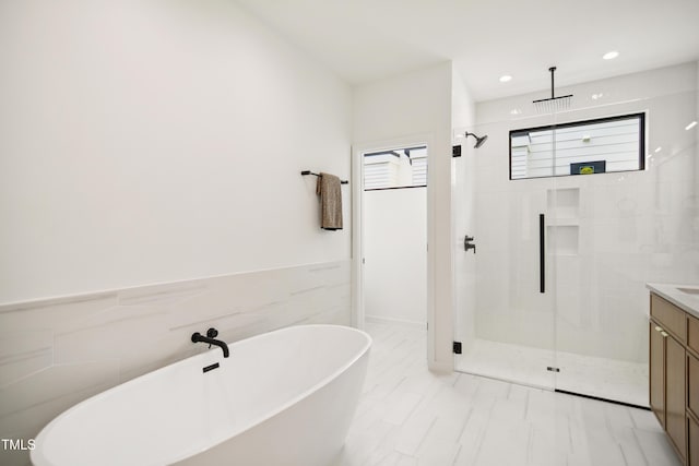 713 N State St, Raleigh, NC 27604 - full bathroom featuring a stall shower, a freestanding bath, vanity, and recessed lighting