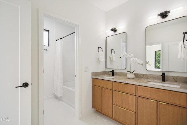 713 N State St, Raleigh, NC 27604 - full bathroom featuring double vanity, shower / bath combo with shower curtain, and tile patterned flooring