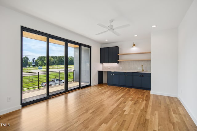713 N State St, Raleigh, NC 27604 - kitchen with light countertops, light wood-style flooring, decorative backsplash, a ceiling fan, and open shelves