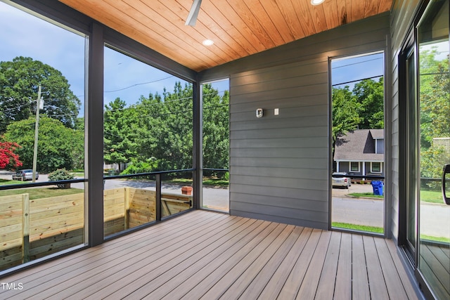 713 N State St, Raleigh, NC 27604 - unfurnished sunroom featuring view of wooded area, ceiling fan, and healthy amount of natural light
