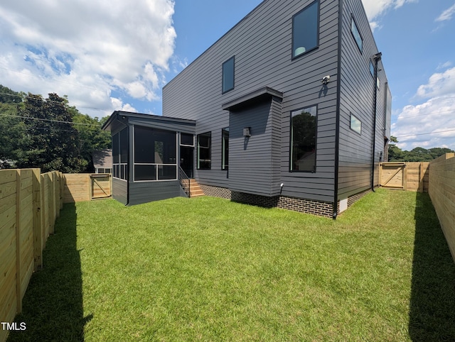 713 N State St, Raleigh, NC 27604 - back of house with a gate, a sunroom, and a fenced backyard