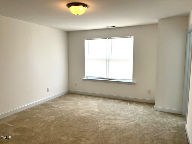 unfurnished room featuring light colored carpet