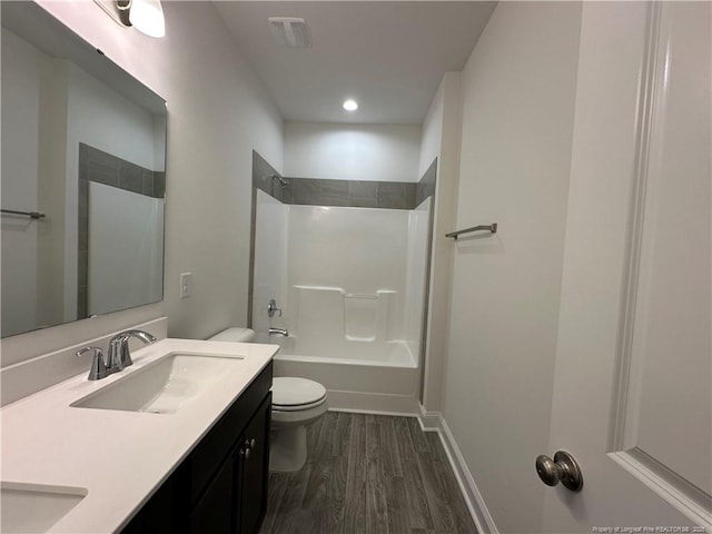 full bathroom featuring vanity, hardwood / wood-style floors, shower / tub combination, and toilet