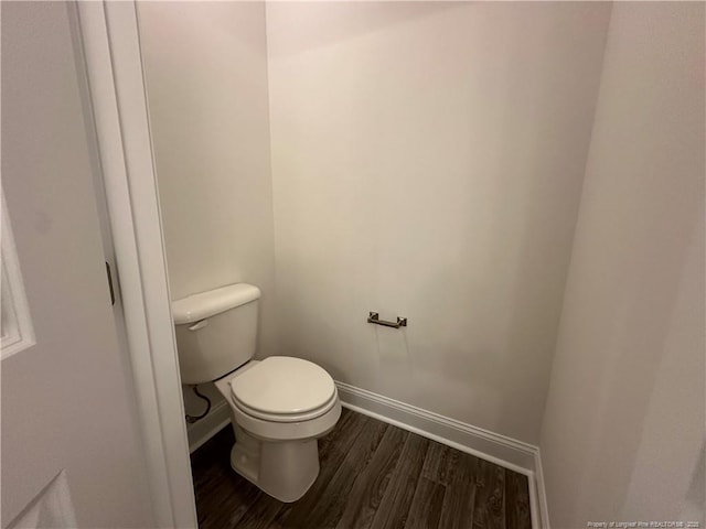 bathroom with toilet and hardwood / wood-style floors