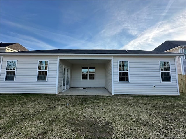 rear view of property with a yard and a patio area