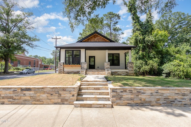 view of front of home with a front lawn and covered porch