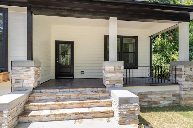 doorway to property featuring a porch