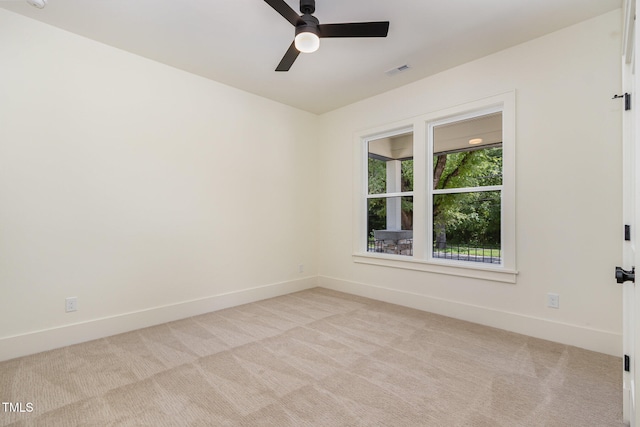 carpeted spare room featuring ceiling fan